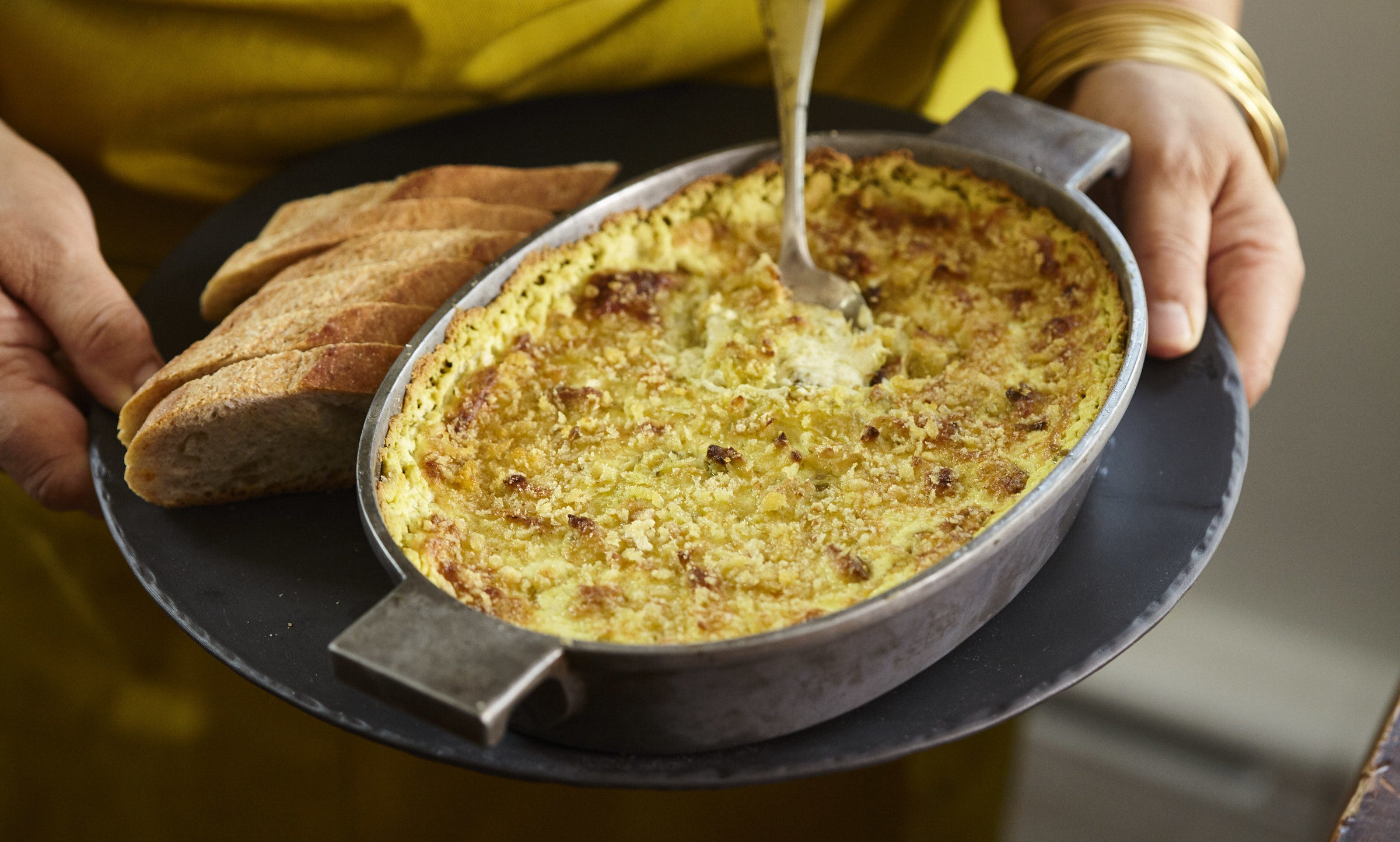 BAKED GOAT CHEESE, FAVA, AND ARTICHOKE DIP Lidia